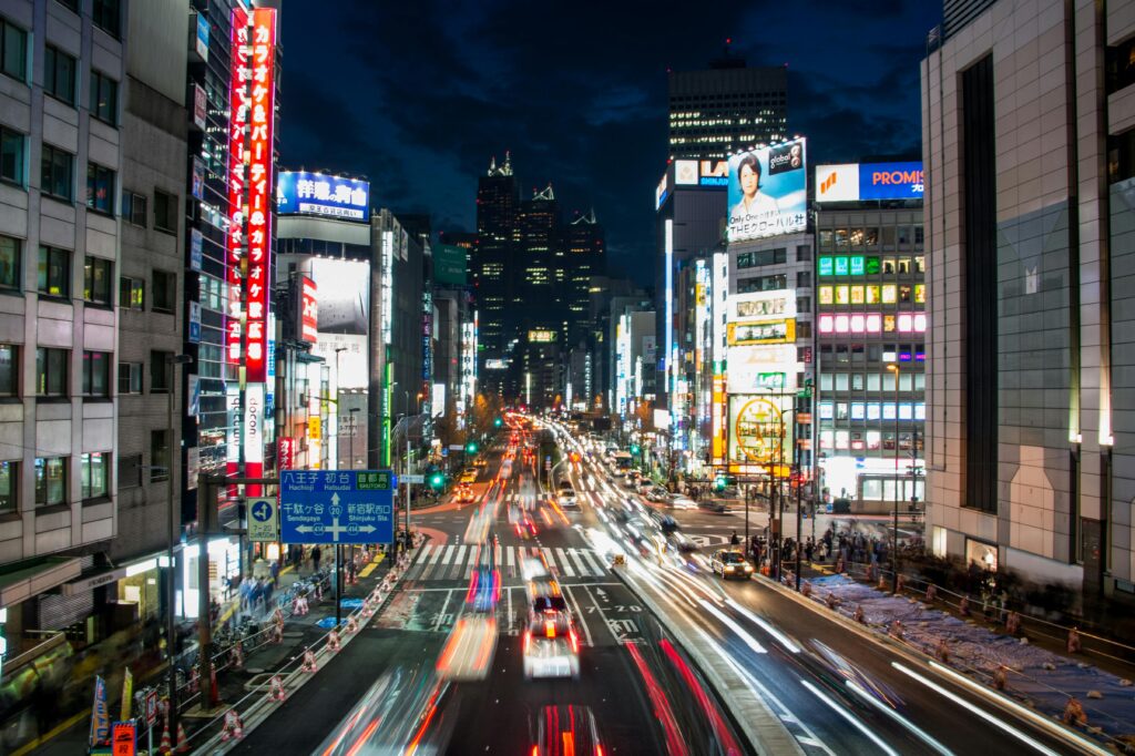 Explore the dynamic night cityscape of Shinjuku, Tokyo, showcasing bright lights and bustling streets.